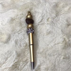 Handcrafted beaded pen. Gold/brown/brown cow print. Made with bpa free silicone